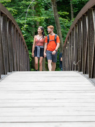 A couple strolling across the bridge at Chittenango Falls State Park
